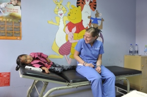Kristen with Jade in the pediatric clinic