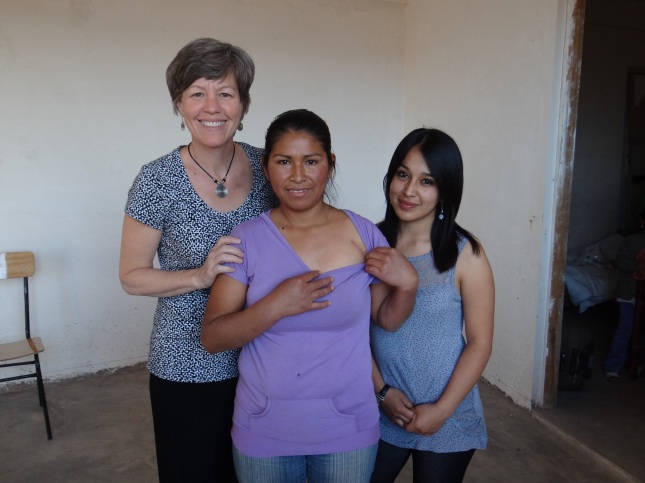 Solidarity Bridge Executive Director, Ann Rhomberg (left), one of our local social workers in Cochabamba, Marizol (right), and Norma (center), a pacemaker surgery patient,  showing off her pacemaker scar