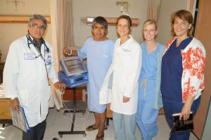 Luis Mercado, MD, Marian Holland, MD, Susan Klosterman, and Cathy Aschbacher, RN reviewing their patient who received an implant the day before.